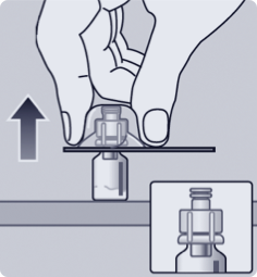 Hand attaching adapter to vial