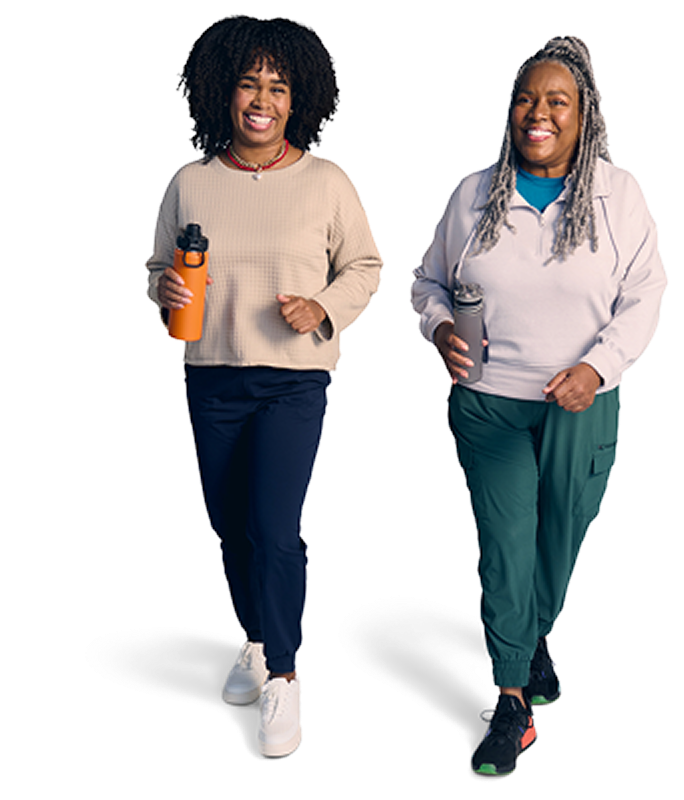 Two women walking and holding water bottles