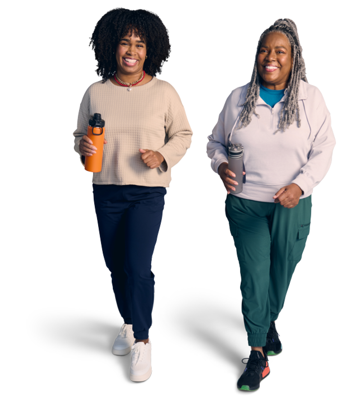 Two women walking and holding water bottles