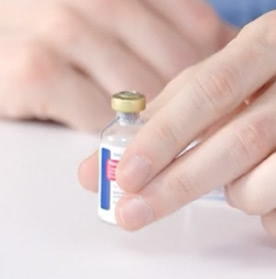 Hand holding a vial