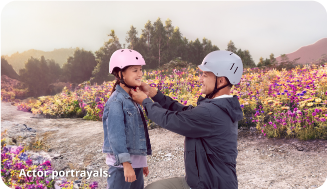 Dad putting on his daughter's helmet Dad putting on his daughter's helmet
